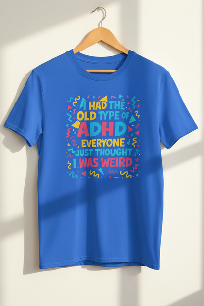 Royal Blue ADHD graphic t-shirt hanging on a wooden hanger against a light wall with natural sunlight
