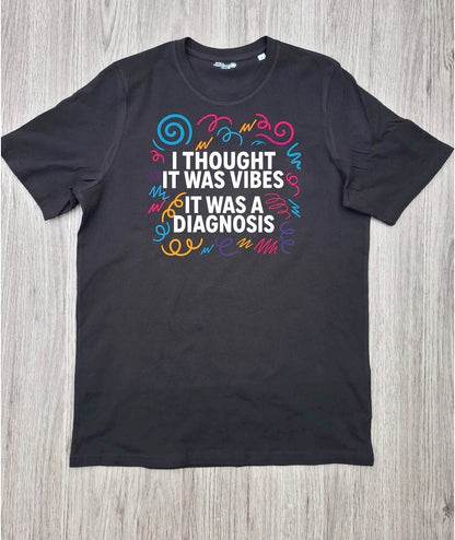I Thought It Was Vibes ADHD T-shirt flat lay on wooden surface