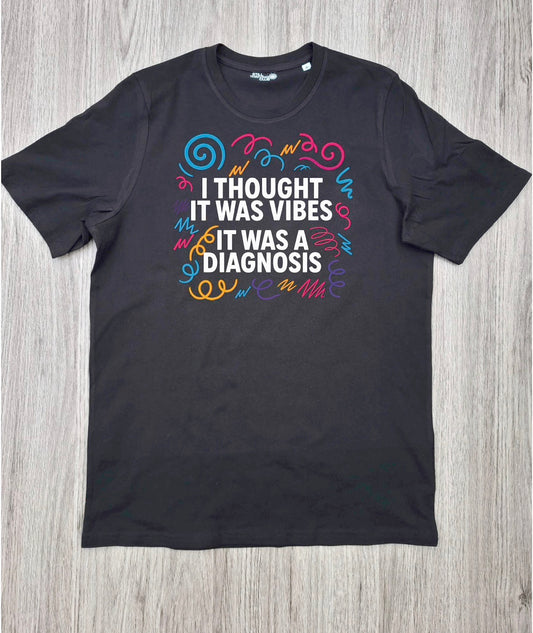 I Thought It Was Vibes ADHD T-shirt flat lay on wooden surface