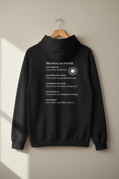 Back view of black Still Thriving Club hoodie with “Why You’re Still Thriving” text design.